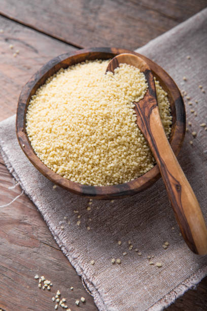 istock Raw Couscous in a wooden bowl on the table 1203252050