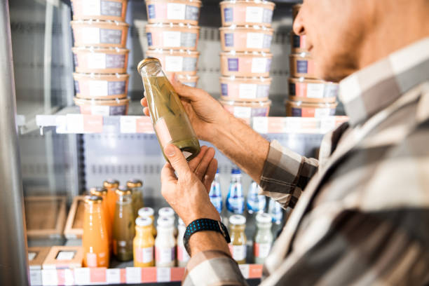 Mature male comparing products at the supermarket