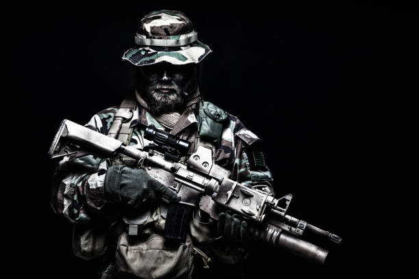 istock Commando soldier in battle ammunition, armed rifle 1203256543
