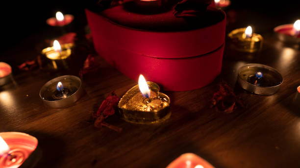 istock Romantic table valentine day with red hearts and candle 1203257401