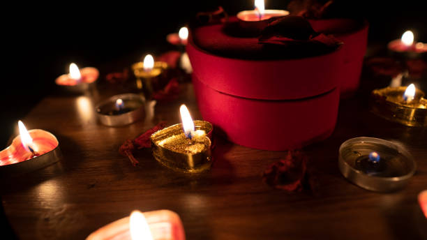 istock Romantic table valentine day with red hearts and candle 1203257411