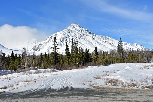 April on the Alcan is a poker game with weather and open campgrounds.  Chains are required in some sections when snow is present up till May