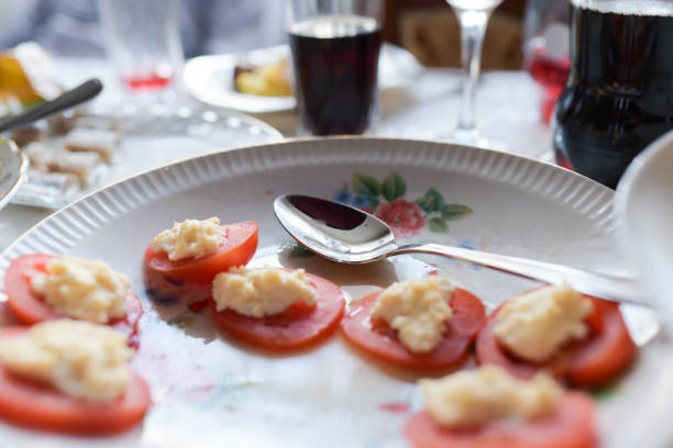 Cheese Tomatoes. Home table, the demand for tomatoes. Stuffed tomatoes with cheese and basil.