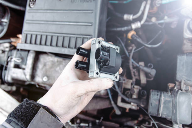 replacing the ignition coil of a car. stock photo