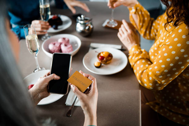 istock Lady paying for order in cafe with cellphone 1203260418