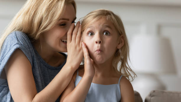 istock Close up surprised curious small kid listening to rumor. 1203260859