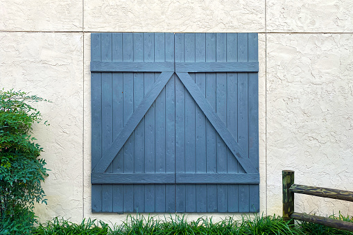 blue barn door white stone building