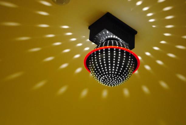 istock Ceiling light spreading pinpoints of brightness in a room 1203262155