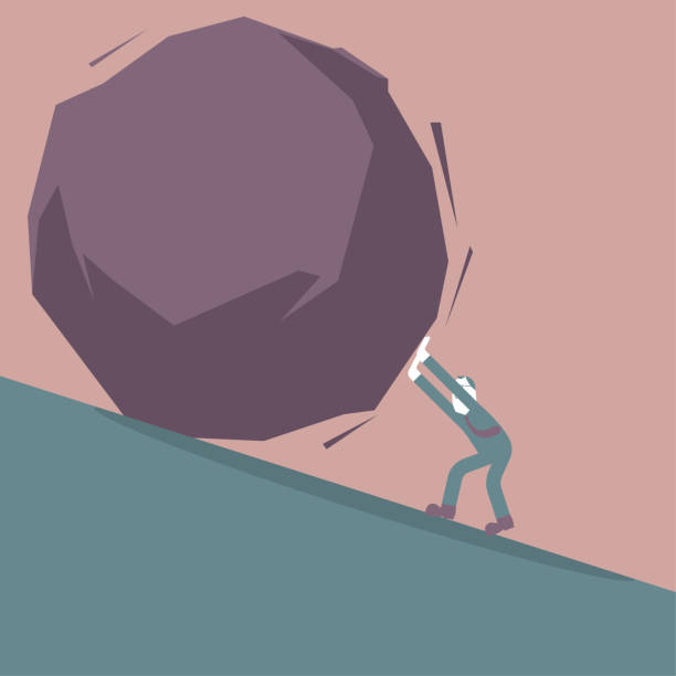 istock A businessman pushes a huge stone on the slope. 1203262904