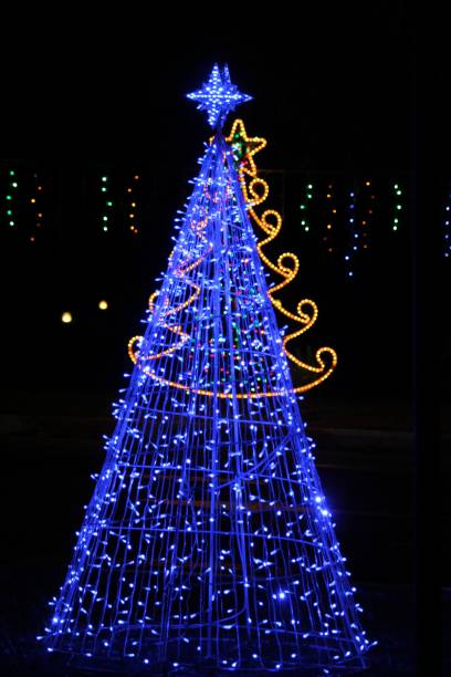 istock Medium close up of a Christmas tree lit by blue lights 1203263145