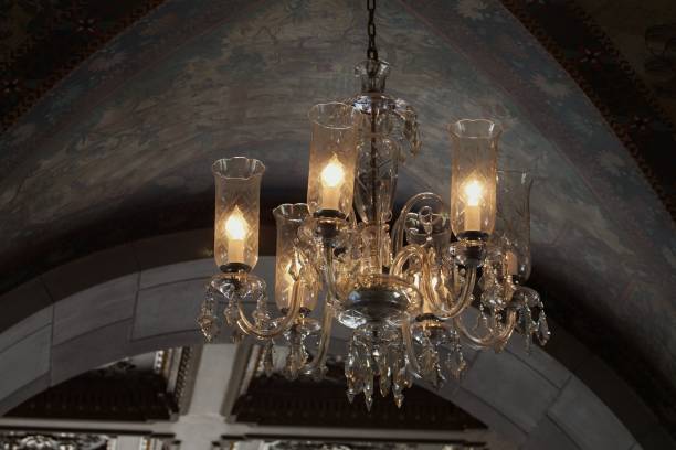 istock Bright bulbs shining from a chandelier from a ceiling 1203263150
