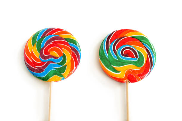 Sweet colorful lolly pops on red background. Tasty color food concept. Top view.