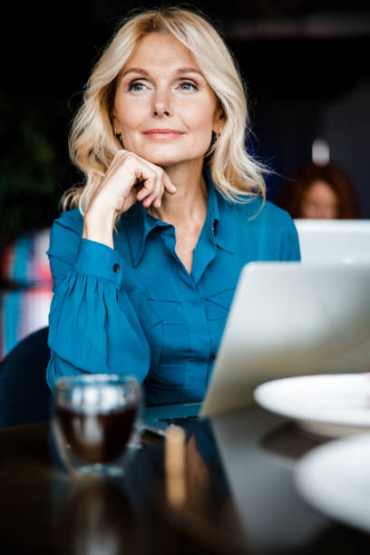Beautiful lady sitting at the table with notebook