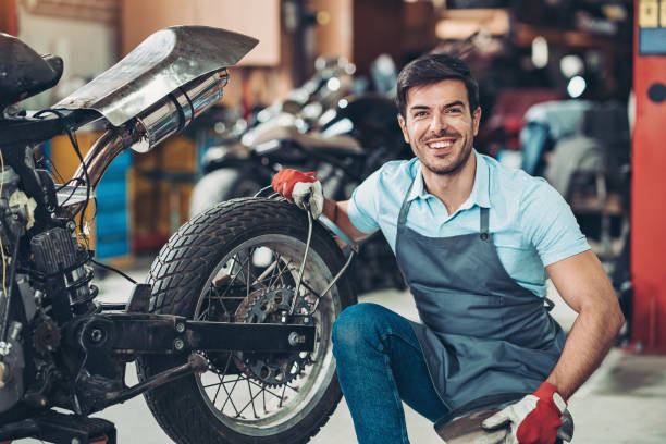 istock Happy mechanic working on a motorcycle 1203265350