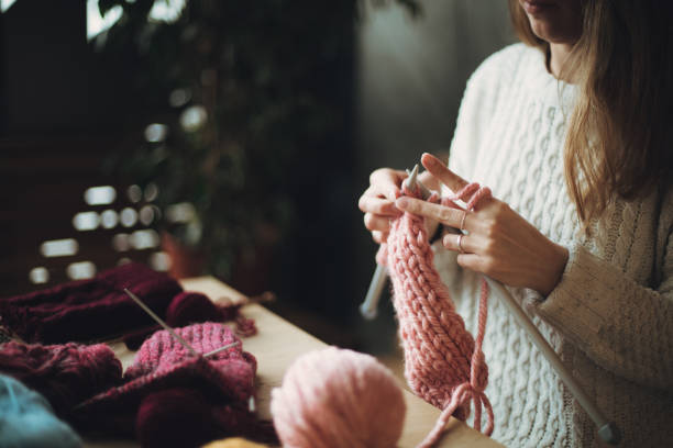 istock Close up on woman's hands knitting 1203266913