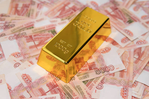 istock gold bar on russian money background 5000 rubles banknotes 1203266983