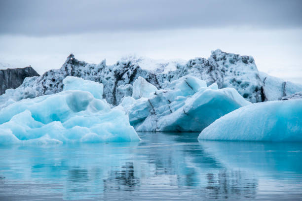 istock Blue icebergs floating in the water 1203267462