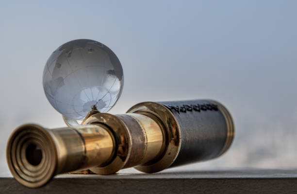 istock Vintage Binocular and Crystal Globe with Sky Background. Travel Concept. 1203267519