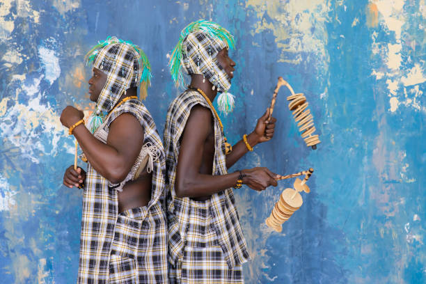 istock African artists with traditional musical instruments on blue wall background. 1203267556