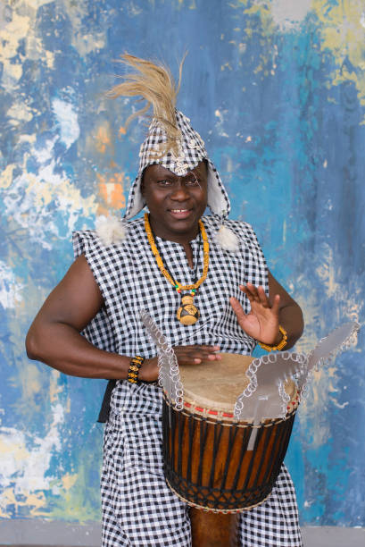 istock African artist in traditional clothes playing djembe drum 1203267593