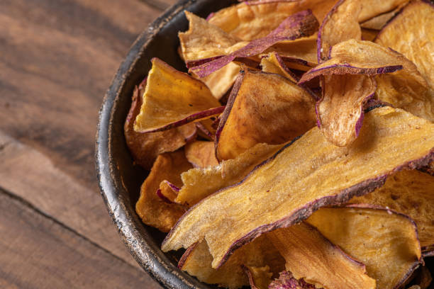 istock Delicious sweet potato chips in bowl, on table 1203269335