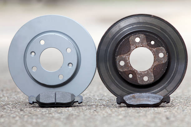 car brake disk and pad. old used and new to change for safety stock photo