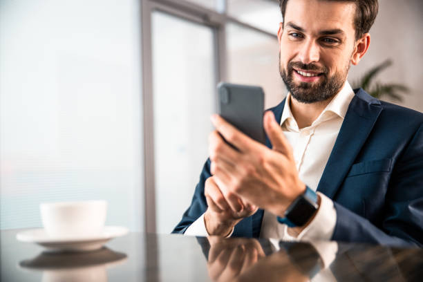istock Happy attractive elegant entrepreneur sending a message 1203270469