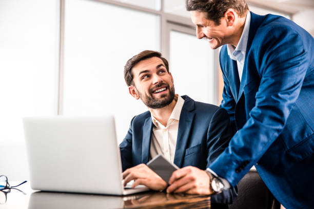 istock Young office worker smiling at his chief 1203270984