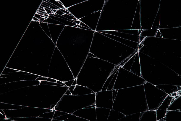 istock cracked glass isolated on a black background. 1203271047