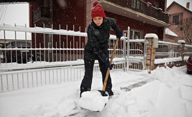 istock Young woman cleans a trail from snow 1203271223