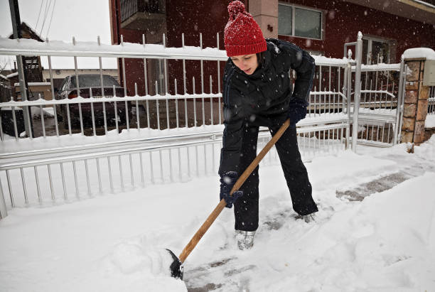 istock Young woman making path in the snow 1203271233