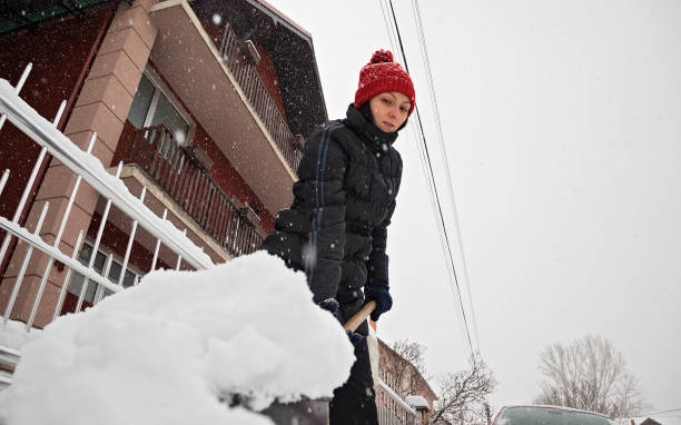 istock Woman making path in the snow 1203271315