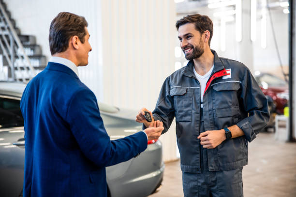 istock Professional mechanic looking at a pleased customer 1203273838