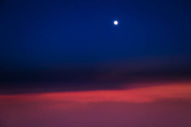 istock Dramatic Sky above clouds and full moon from airplane window – Usa, North America 1203276315