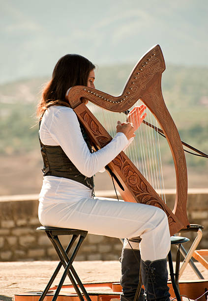 istock Young Woman playing a harp 120327729