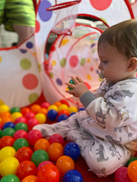 istock Infant playing in a ballpen 1203277670
