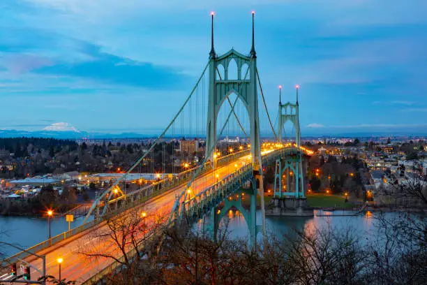 St Johns Bridge over the Willamette River in Portland, Oregon with Mt St Helens and Mt Adams in the background.