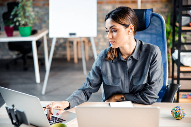 istock Concentrated brunette female working with partners online 1203279389