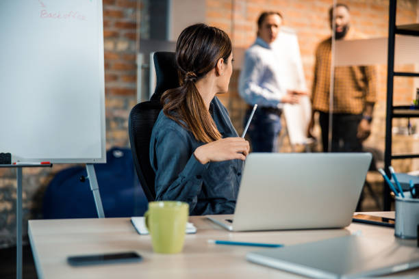 istock Kind woman turning head to her colleagues 1203279994