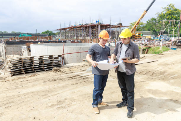 istock Construction concept of Engineer and Architect working at Construction Site with blue print 1203281005