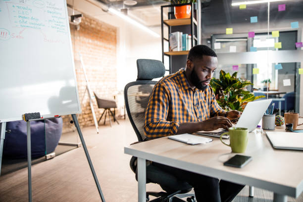 istock Serious international man staring at his computer 1203282684