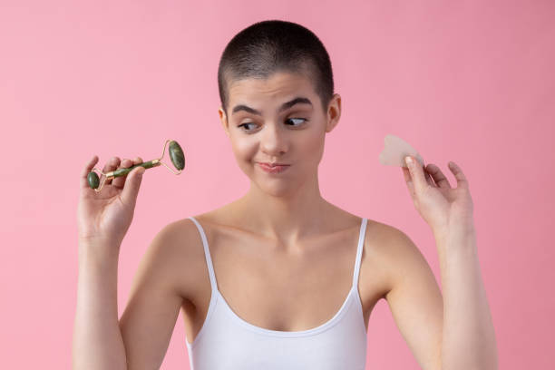 istock Funny lady choosing Gua Sha tool for herself stock photo 1203287393