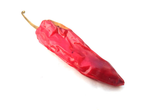 istock Dried red chili or chilli cayenne pepper isolated on white background cutout 1203294645