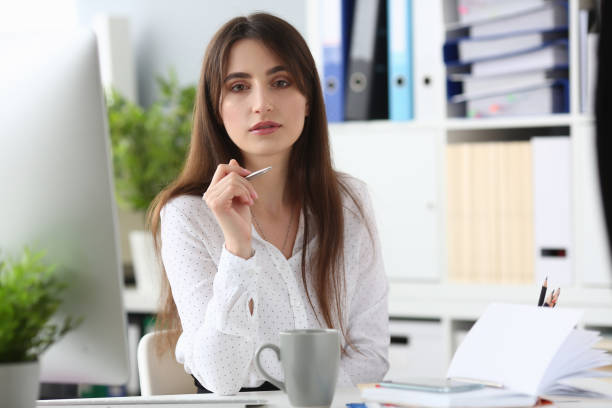 istock Pretty woman having break at workplace 1203296111