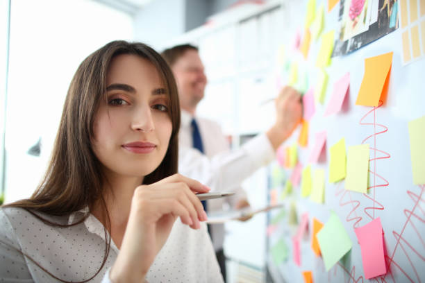 istock Lovely woman holding pen 1203296120