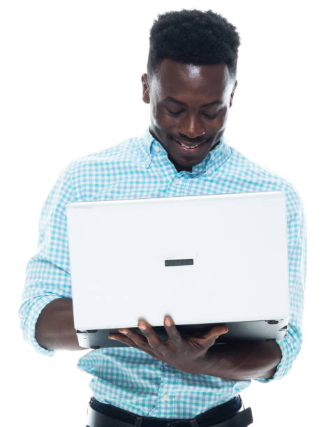 istock African-american ethnicity male standing wearing pants and using laptop 1203296446