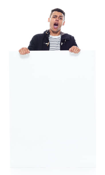 istock African ethnicity male standing wearing jacket and holding placard 1203299731