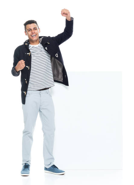 istock African ethnicity male standing wearing jacket and holding placard 1203299748