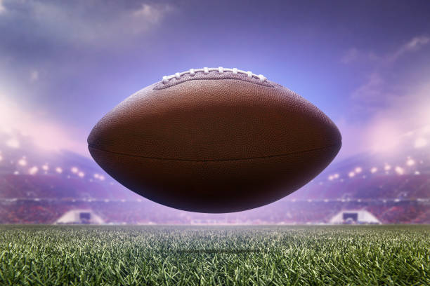 photo american football ball on stadium background. stock photo
