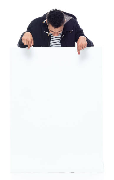 istock African ethnicity male standing wearing jacket and holding placard 1203299817
